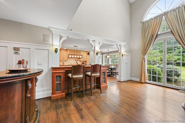 16 Oak Blf, Avon, CT 06001 - bar with a towering ceiling, dark wood-style flooring, ventilation hood, and decorative light fixtures