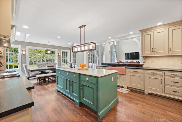 16 Oak Blf, Avon, CT 06001 - kitchen featuring cream cabinetry, dark wood finished floors, a center island with sink, tasteful backsplash, and recessed lighting