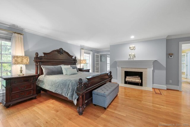16 Oak Blf, Avon, CT 06001 - bedroom featuring light wood-style floors, crown molding, a fireplace with flush hearth, and recessed lighting