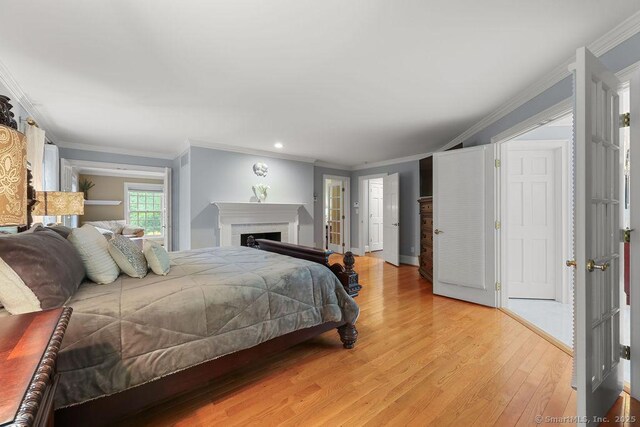 16 Oak Blf, Avon, CT 06001 - bedroom with light wood-type flooring, ornamental molding, recessed lighting, and a fireplace