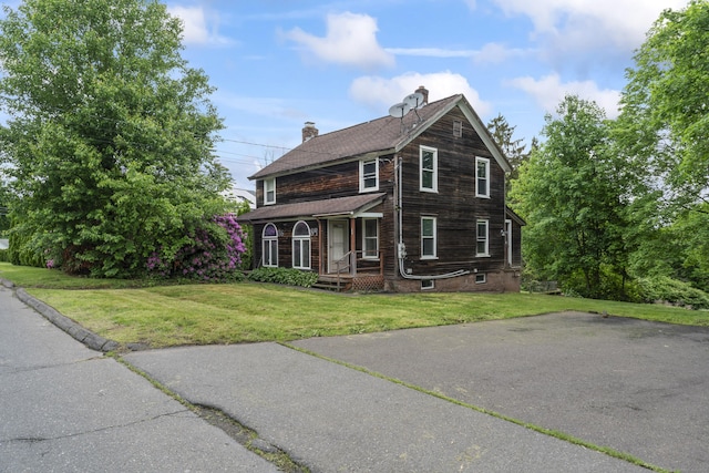 84 George St, Middletown, CT 06457 - view of front of house with covered porch, a chimney, and a front yard