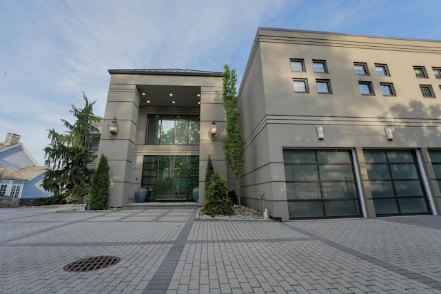 5050 Main St, Stratford, CT 06614 - view of building exterior featuring decorative driveway and a garage