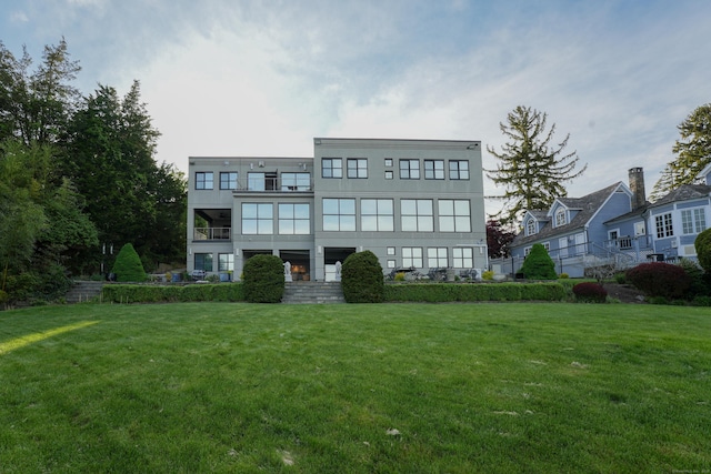 5050 Main St, Stratford, CT 06614 - rear view of property featuring a balcony and a lawn