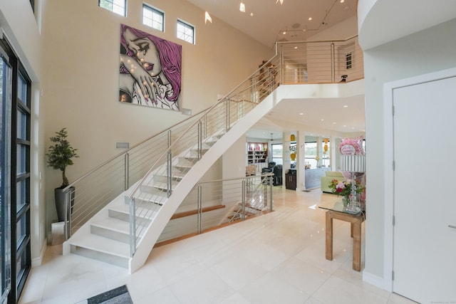 5050 Main St, Stratford, CT 06614 - tiled entrance foyer with a towering ceiling, healthy amount of natural light, stairs, and recessed lighting