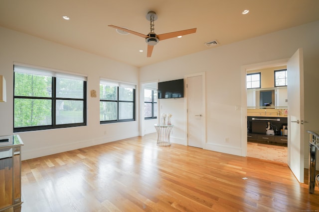 5050 Main St, Stratford, CT 06614 - unfurnished bedroom with light wood-style floors, multiple windows, baseboards, and recessed lighting