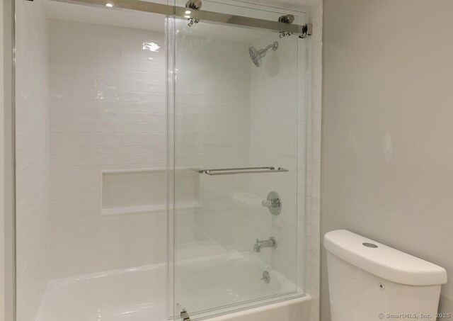 143 Heritage Vlg Unit E, Southbury, CT 06488 - bathroom with toilet and shower / bath combination with glass door