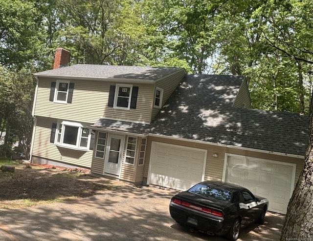 33 Hillsdale Dr, Ellington, CT 06029 - view of front of house with a garage, a chimney, driveway, and roof with shingles