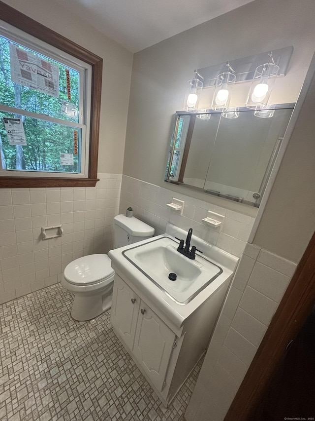 33 Hillsdale Dr, Ellington, CT 06029 - bathroom featuring tile walls, toilet, vanity, and a wainscoted wall