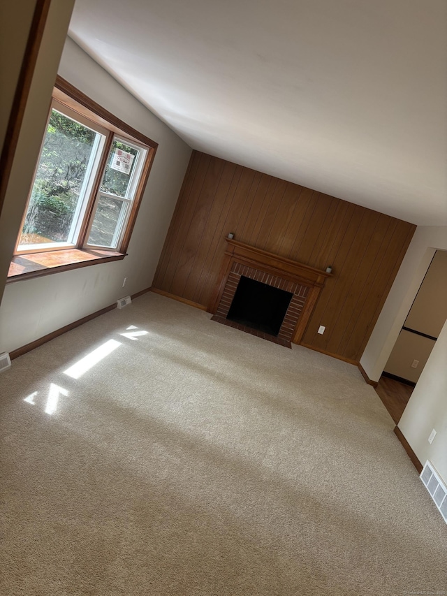 33 Hillsdale Dr, Ellington, CT 06029 - unfurnished living room featuring baseboards, carpet floors, a brick fireplace, and wooden walls