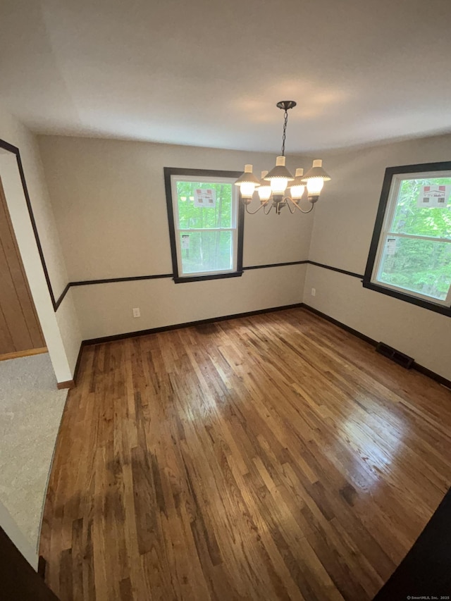 33 Hillsdale Dr, Ellington, CT 06029 - spare room with a chandelier, hardwood / wood-style flooring, and baseboards