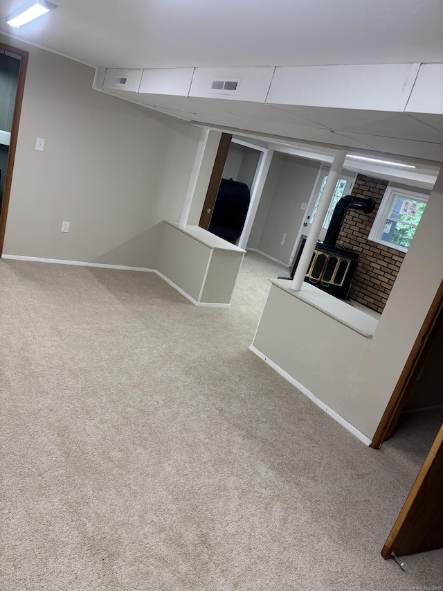 33 Hillsdale Dr, Ellington, CT 06029 - below grade area featuring a wood stove, carpet, and baseboards