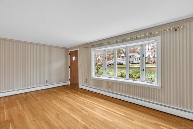192 Hilton Dr, South Windsor, CT 06074 - unfurnished living room featuring a baseboard radiator, light wood-type flooring, wallpapered walls, and healthy amount of natural light