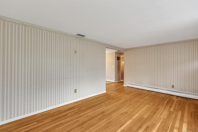 192 Hilton Dr, South Windsor, CT 06074 - spare room with light wood-type flooring, a baseboard radiator, baseboards, and wallpapered walls
