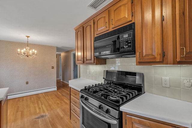 192 Hilton Dr, South Windsor, CT 06074 - kitchen with stainless steel gas range, black microwave, baseboard heating, and brown cabinets