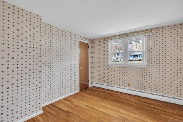 192 Hilton Dr, South Windsor, CT 06074 - spare room with light wood-style floors, a baseboard heating unit, wallpapered walls, and baseboards