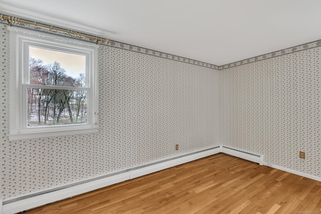 192 Hilton Dr, South Windsor, CT 06074 - unfurnished room with a baseboard heating unit, wallpapered walls, light wood-type flooring, and baseboards