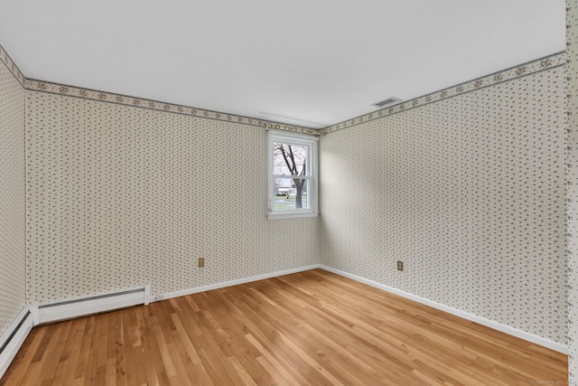 192 Hilton Dr, South Windsor, CT 06074 - empty room featuring wallpapered walls, light wood-style flooring, baseboards, and a baseboard radiator
