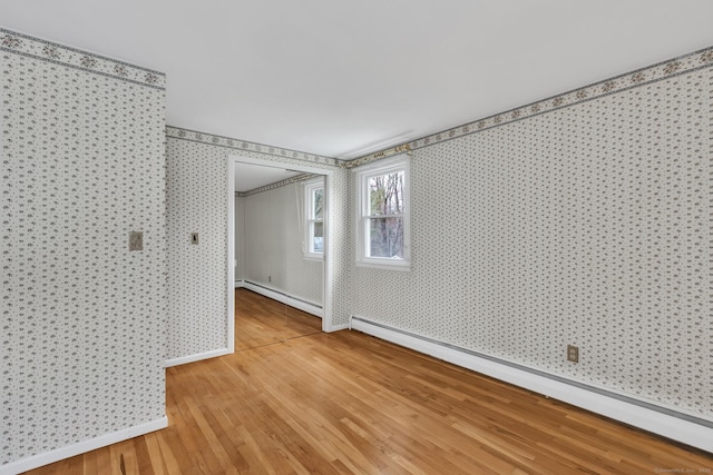 192 Hilton Dr, South Windsor, CT 06074 - empty room with baseboard heating, wallpapered walls, light wood finished floors, and baseboards