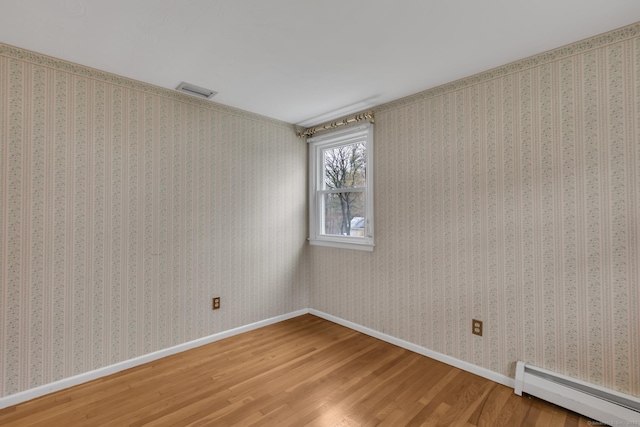 192 Hilton Dr, South Windsor, CT 06074 - spare room featuring baseboard heating, wood finished floors, and baseboards