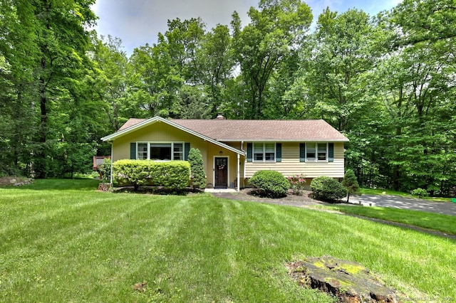 9 Honey Ln, Newtown, CT 06482 - bi-level home featuring a front lawn and roof with shingles