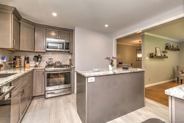 9 Honey Ln, Newtown, CT 06482 - kitchen with stainless steel appliances, crown molding, backsplash, light stone counters, and a center island