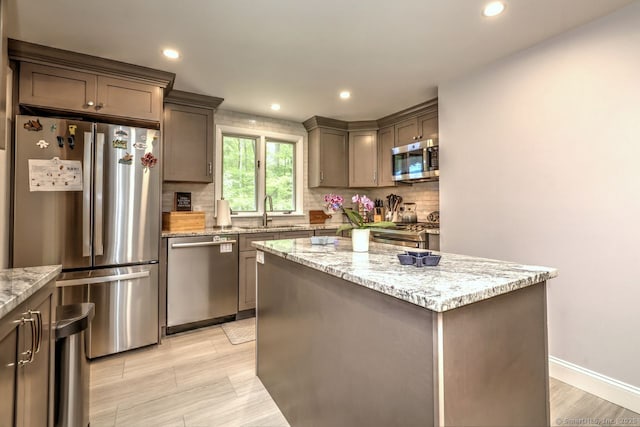 9 Honey Ln, Newtown, CT 06482 - kitchen with stainless steel appliances, backsplash, a sink, a kitchen island, and recessed lighting