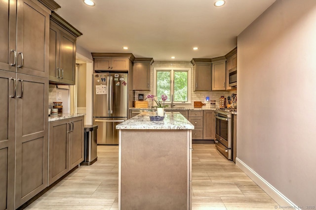 9 Honey Ln, Newtown, CT 06482 - kitchen with appliances with stainless steel finishes, a center island, recessed lighting, backsplash, and light stone counters