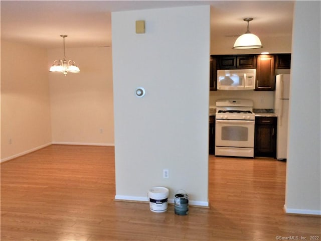 18 Greenview Ln Unit 18, Milford, CT 06461 - kitchen featuring white appliances, light wood-style floors, a chandelier, and pendant lighting
