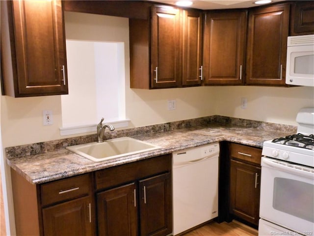 18 Greenview Ln Unit 18, Milford, CT 06461 - kitchen with white appliances, dark brown cabinetry, and light wood-style flooring