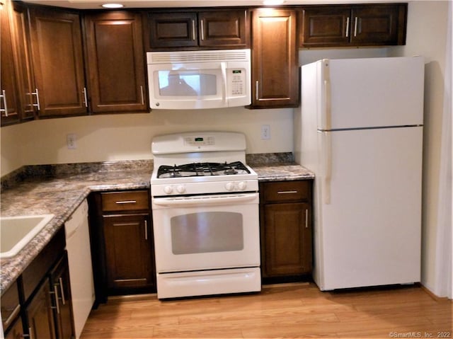 18 Greenview Ln Unit 18, Milford, CT 06461 - kitchen with white appliances, light wood finished floors, and dark brown cabinetry