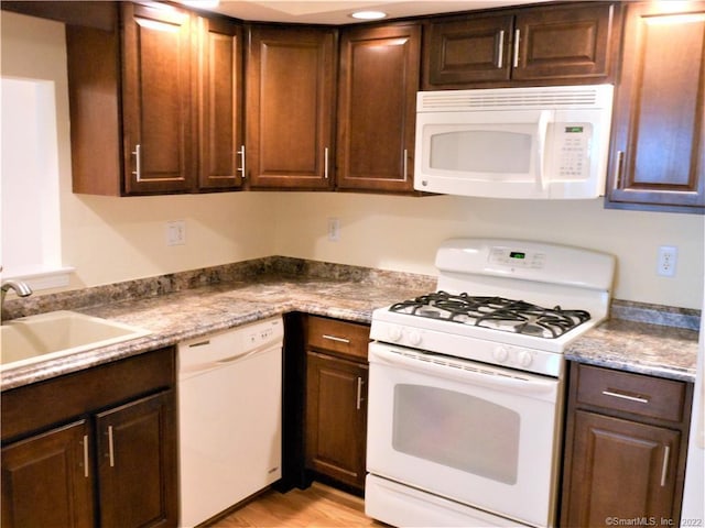 18 Greenview Ln Unit 18, Milford, CT 06461 - kitchen with white appliances, light wood-type flooring, and dark brown cabinets