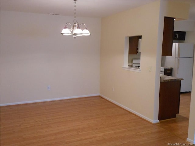 18 Greenview Ln Unit 18, Milford, CT 06461 - empty room with light wood-type flooring and a chandelier
