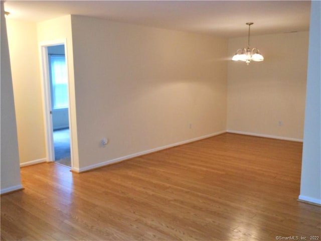 18 Greenview Ln Unit 18, Milford, CT 06461 - unfurnished room with a chandelier and wood finished floors