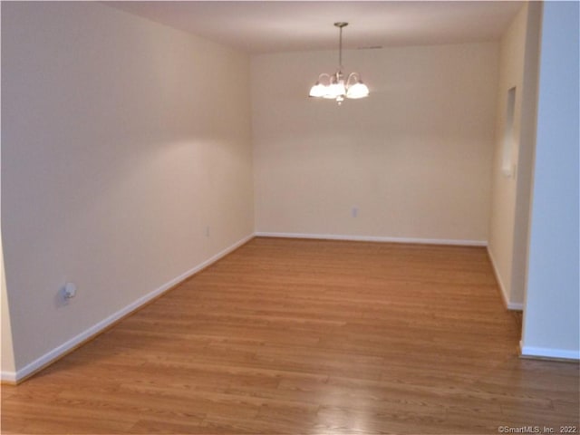 18 Greenview Ln Unit 18, Milford, CT 06461 - spare room featuring a chandelier and light wood-type flooring
