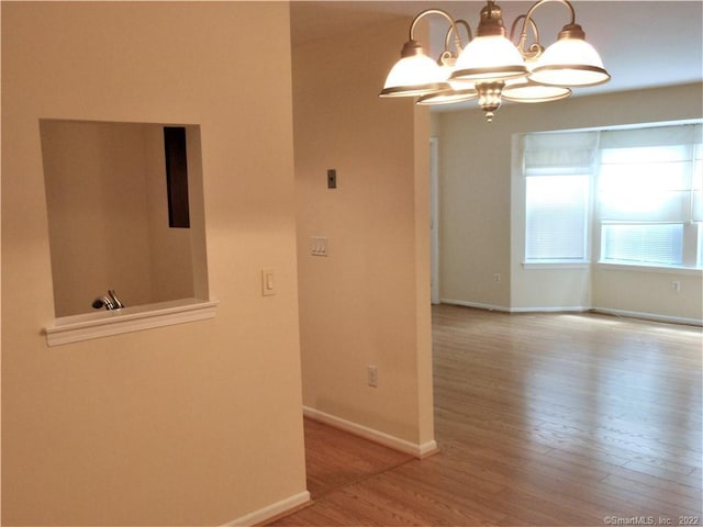 18 Greenview Ln Unit 18, Milford, CT 06461 - empty room with wood finished floors and a chandelier