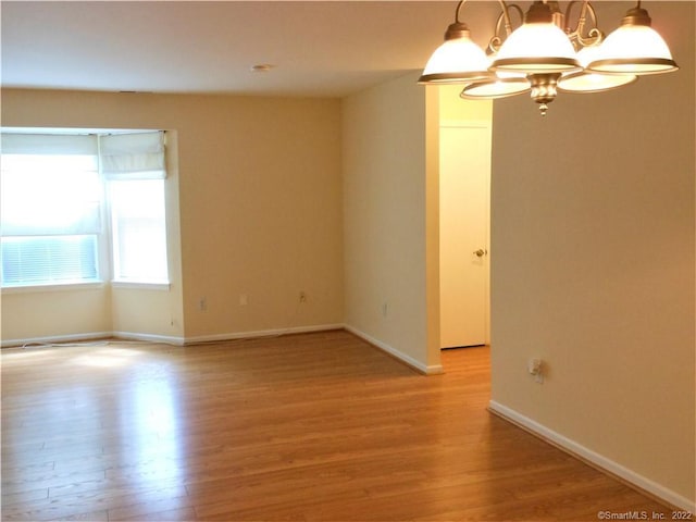 18 Greenview Ln Unit 18, Milford, CT 06461 - unfurnished room with light wood finished floors and a chandelier
