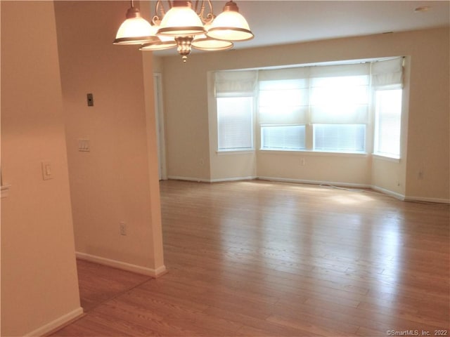 18 Greenview Ln Unit 18, Milford, CT 06461 - unfurnished room featuring wood finished floors and a chandelier