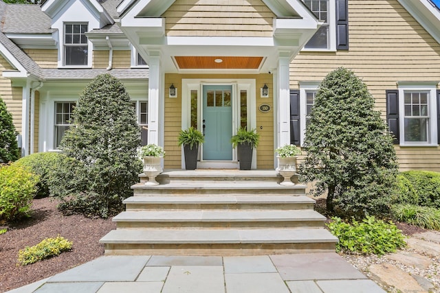 110 Florence Ln, Fairfield, CT 06824 - view of exterior entry with roof with shingles and covered porch