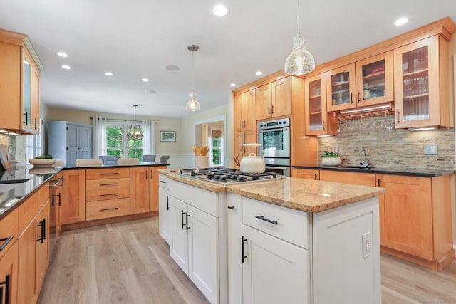 110 Florence Ln, Fairfield, CT 06824 - kitchen featuring stainless steel appliances, light wood-style floors, backsplash, recessed lighting, and dark stone counters