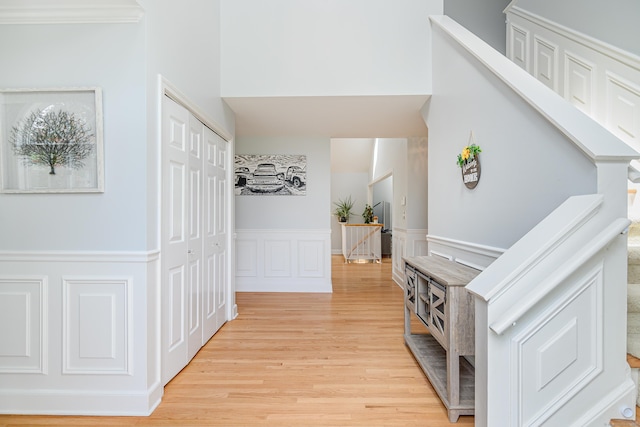 101 Railtree Hill Rd, Woodbury, CT 06798 - hallway featuring an upstairs landing, wainscoting, light wood-style flooring, and a decorative wall