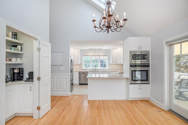 101 Railtree Hill Rd, Woodbury, CT 06798 - kitchen featuring stainless steel appliances, a sink, a chandelier, white cabinets, and light wood-type flooring