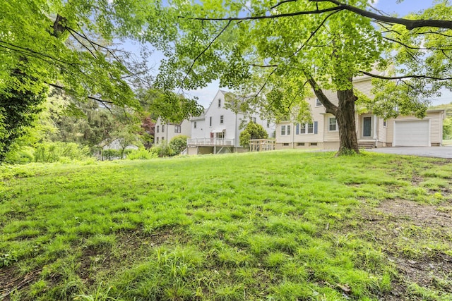 1897 Stanley St, New Britain, CT 06053 - view of green lawn with a garage and asphalt driveway