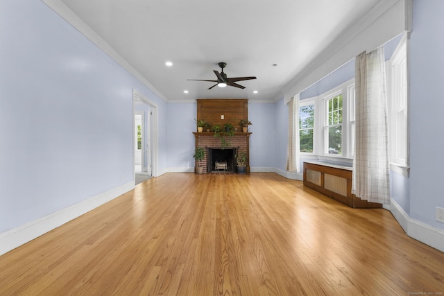 1897 Stanley St, New Britain, CT 06053 - unfurnished living room featuring a ceiling fan, light wood finished floors, a fireplace, baseboards, and recessed lighting