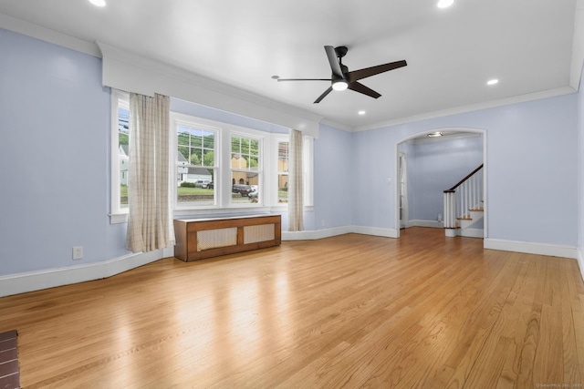 1897 Stanley St, New Britain, CT 06053 - unfurnished living room with ceiling fan, arched walkways, crown molding, light wood finished floors, and baseboards