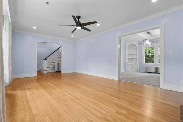 1897 Stanley St, New Britain, CT 06053 - unfurnished living room featuring radiator, a ceiling fan, light wood-type flooring, crown molding, and baseboards