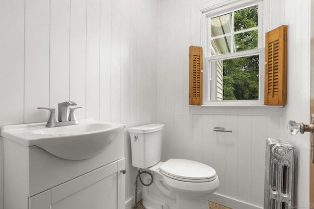 1897 Stanley St, New Britain, CT 06053 - half bathroom with radiator, toilet, and vanity