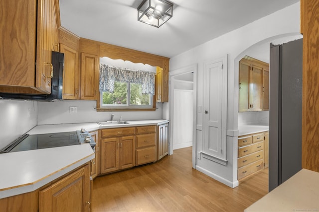 1897 Stanley St, New Britain, CT 06053 - kitchen with a sink, light wood finished floors, and light countertops