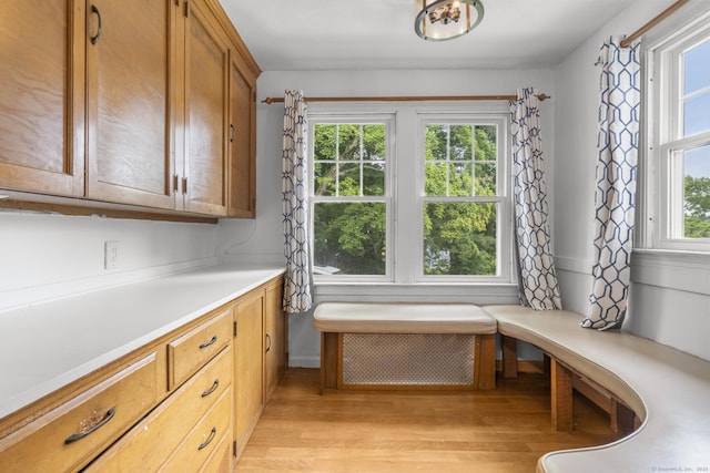 1897 Stanley St, New Britain, CT 06053 - kitchen with light wood-style floors, light countertops, and brown cabinetry