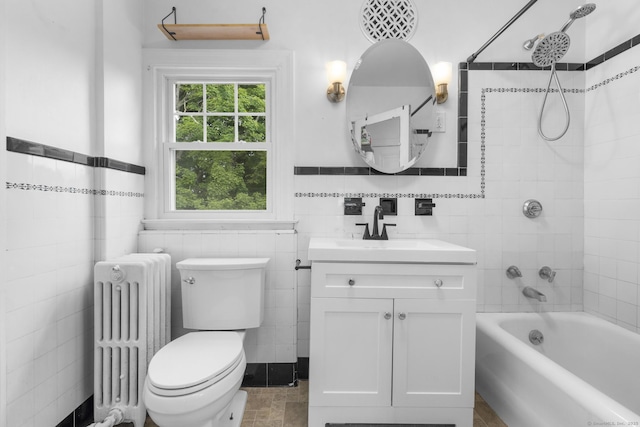 1897 Stanley St, New Britain, CT 06053 - bathroom featuring radiator heating unit, tile walls, vanity, toilet, and shower / bathtub combination