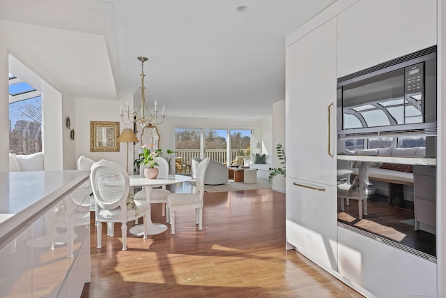 123 Harbor Dr Apt 403, Stamford, CT 06902 - dining area featuring a chandelier and light wood-type flooring